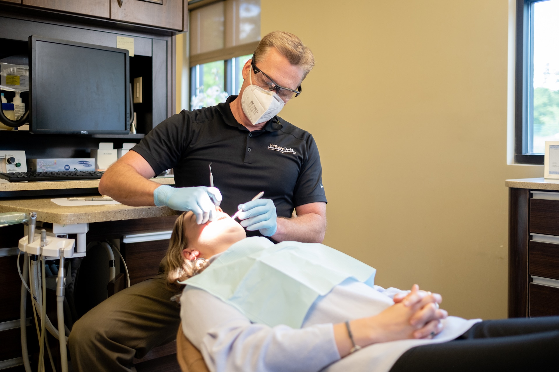 Dentist working on patient in chair