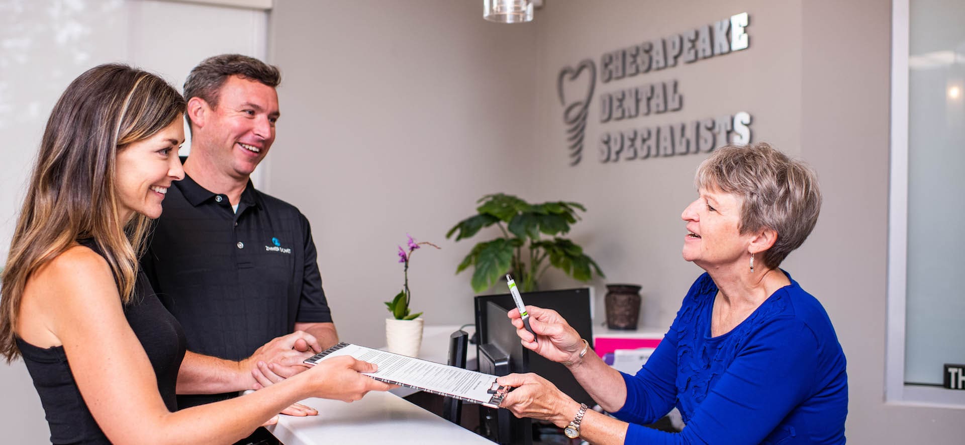 Dentist office staff chatting at desk