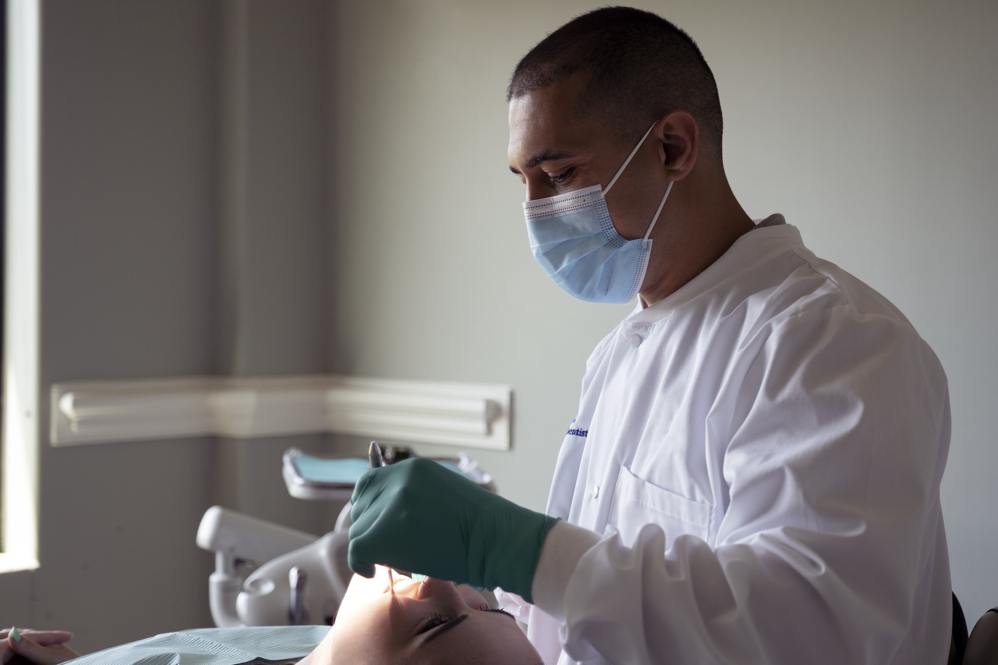 Dentist working on patient in operatory