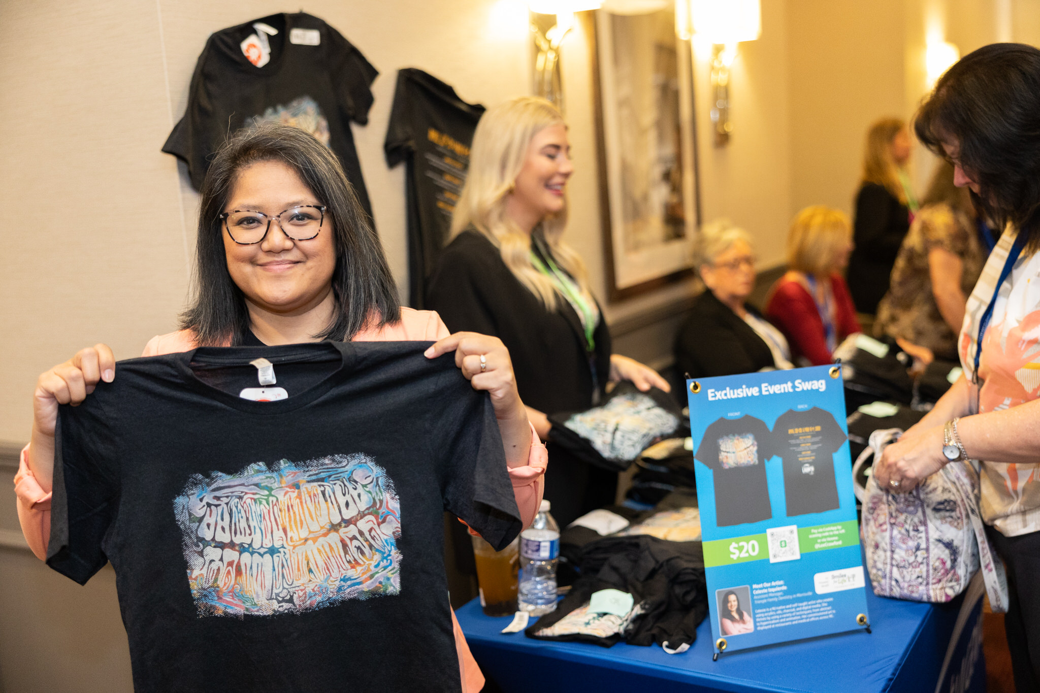 An individual showing off t-shirt event swag