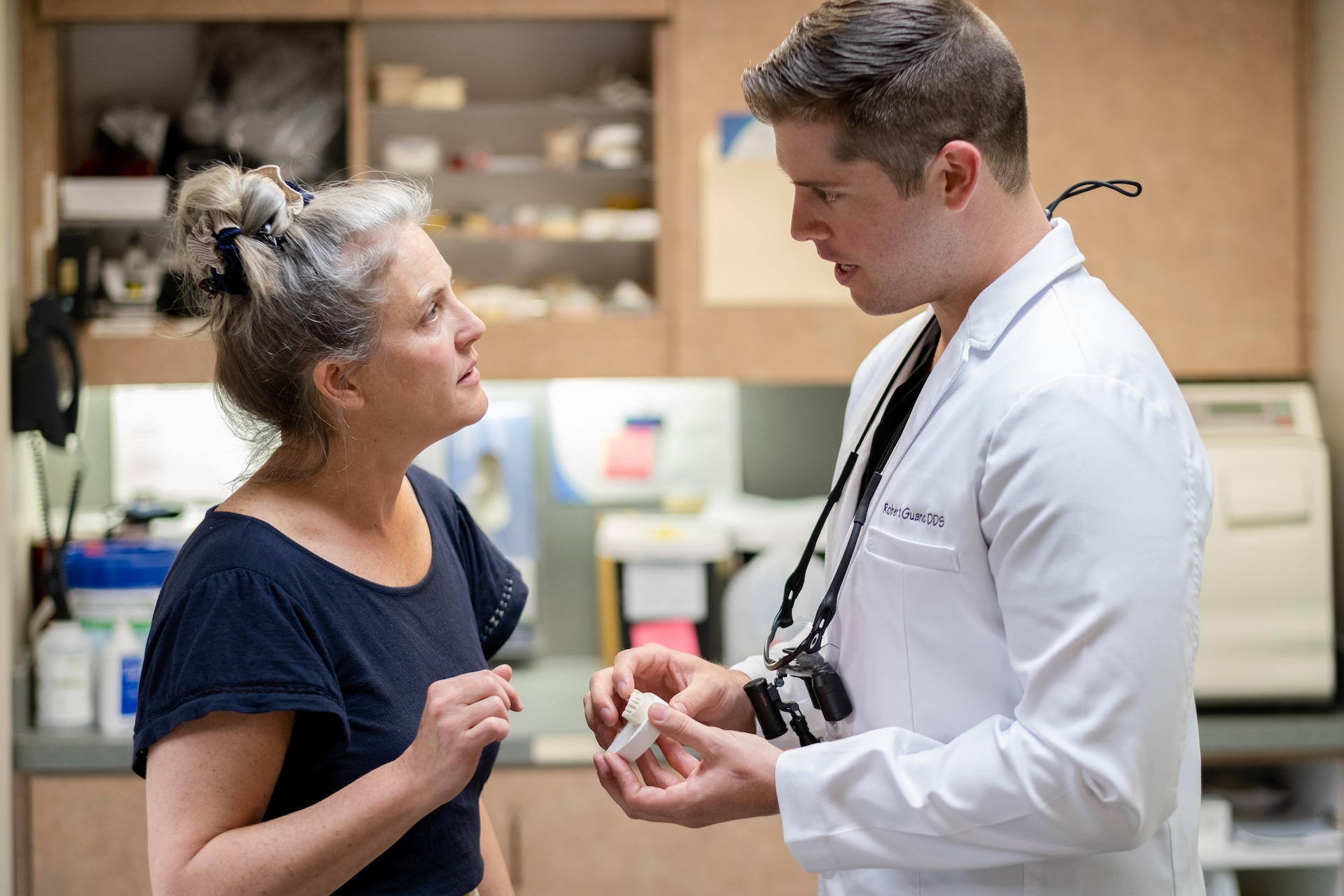 woman talking to dentist in a dental leadership organization