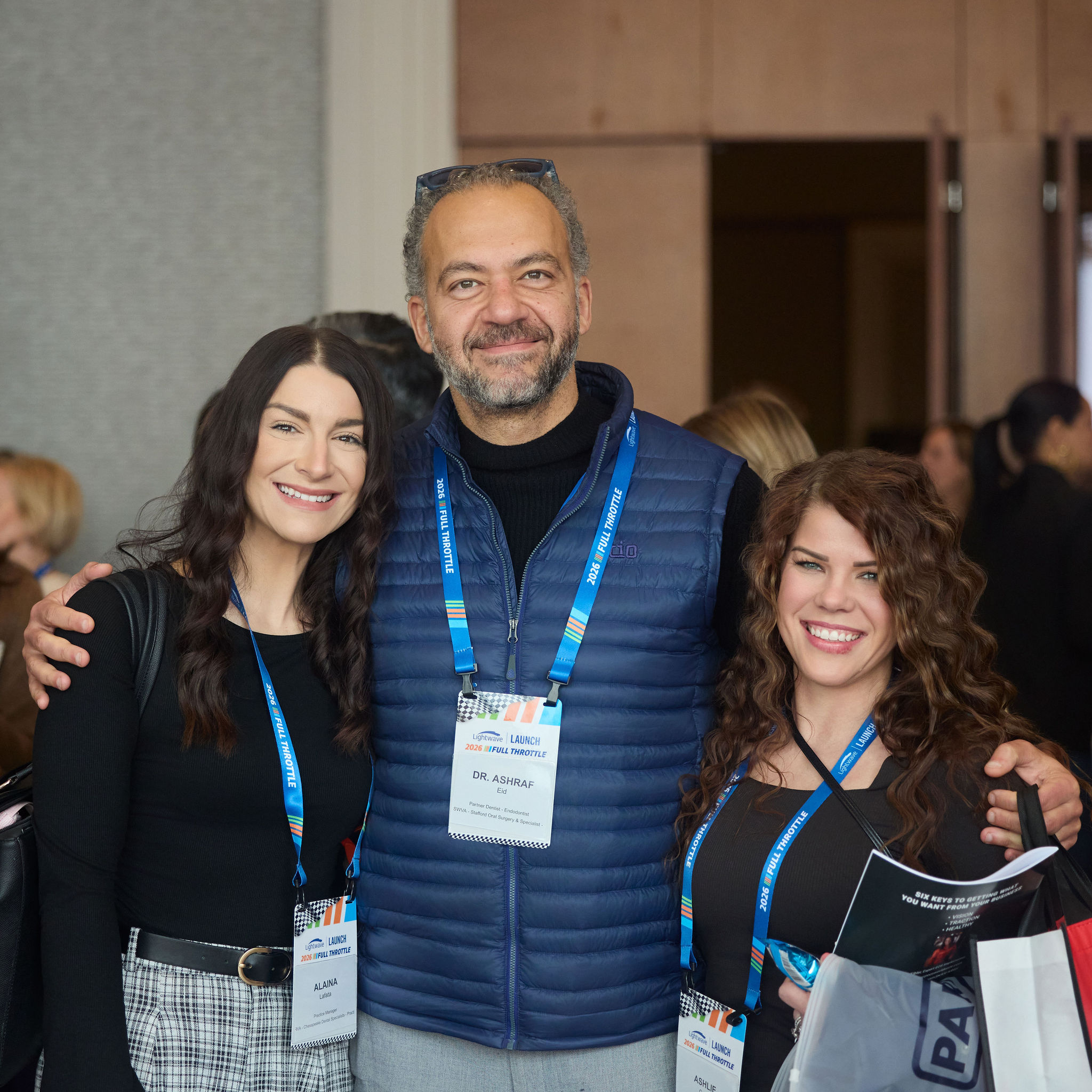 Three dental professionals at a networking event